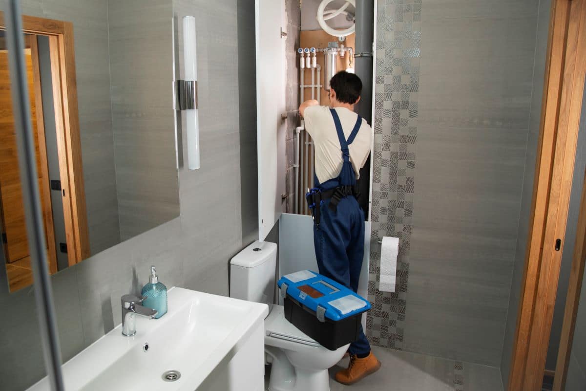 How Much Does a Bathroom Remodel Cost in Eugene, OR? 3 male plumber working fix problems client s house