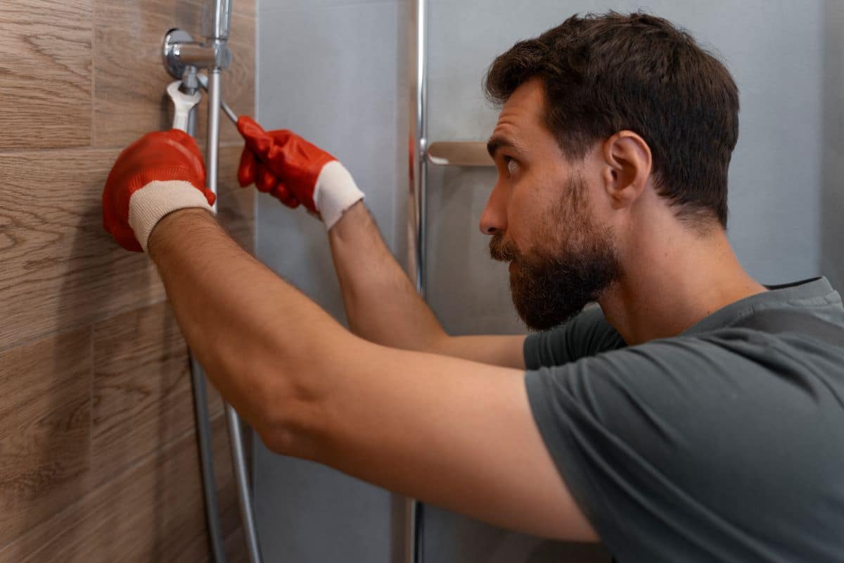 How Much Does a Bathroom Remodel Cost in Eugene, OR? 5 side view man working as plumber